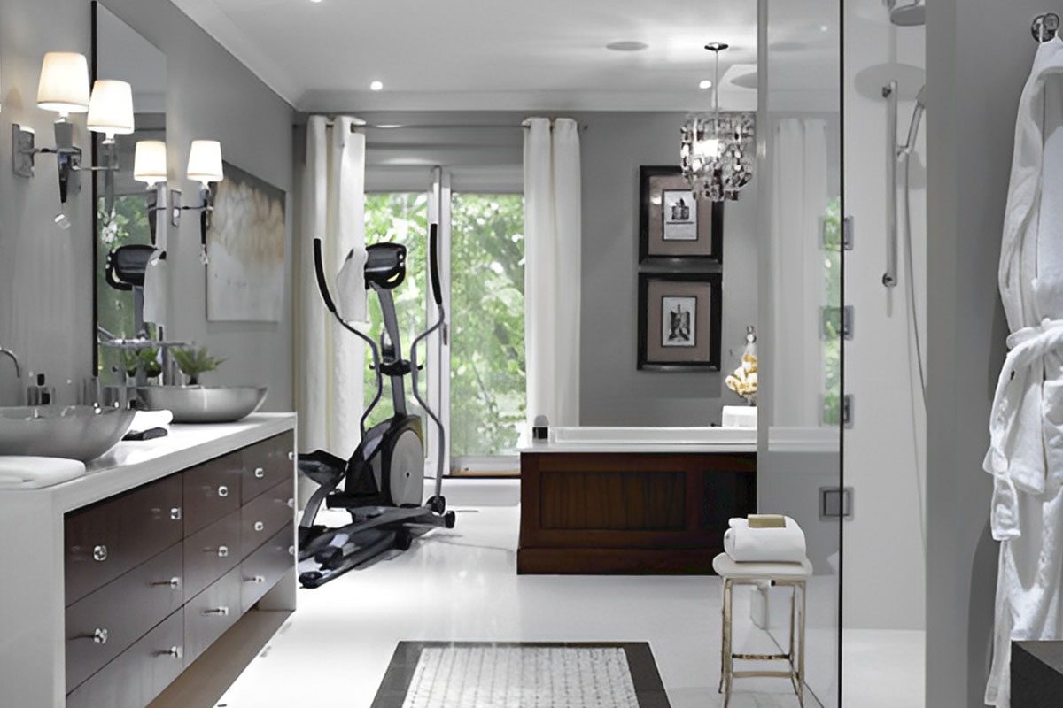 A modern bathroom features a double sink vanity, an elliptical machine, a bathtub, and a glass shower. White and gray tones dominate the decor.