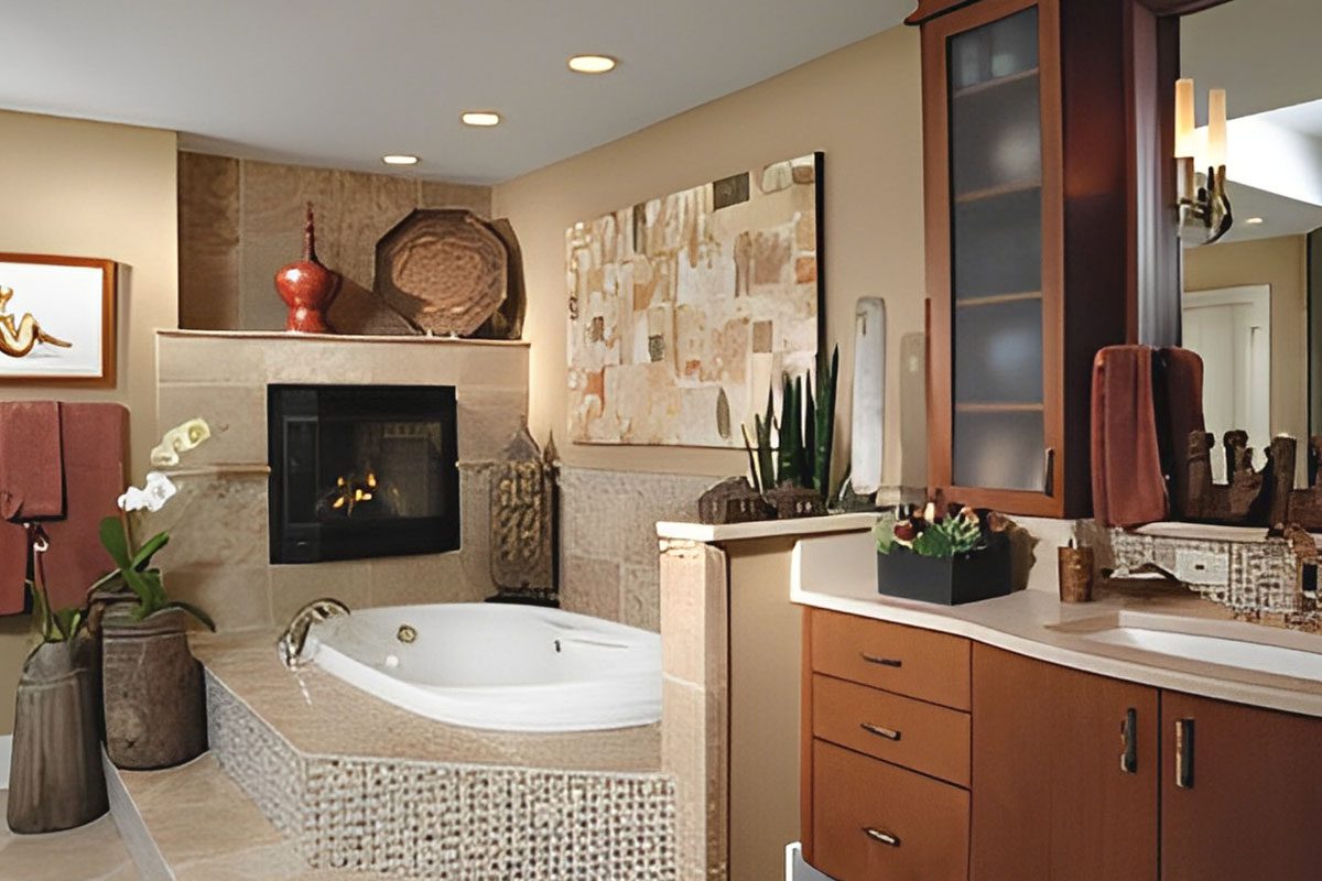A modern bathroom with a jacuzzi tub, fireplace, and wall art. Wooden cabinets, countertop, and various decorative items enhance the decor.